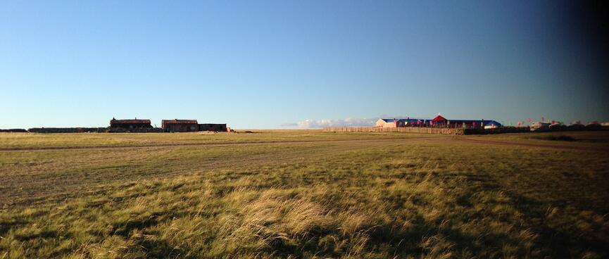 A handful of wooden buildings and traditional gers.