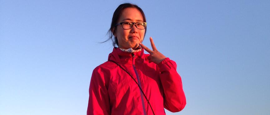 Mandyʼs pink jacket matches the pink hue on the horizon.