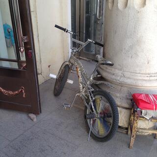 A stunt BMX is painted with spots and a cheetah.
