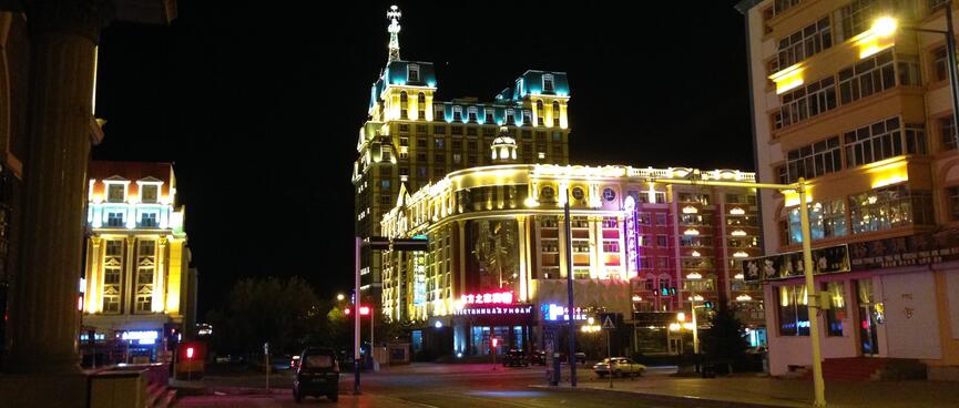 Teal lit towers stand out in a sea of yellow lighting.