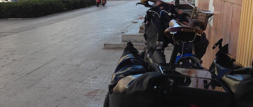 Pannier bags and a solar panel grace the rear of my touring bike.