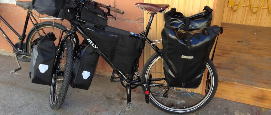 Frame and panniers gleam in the daylight.