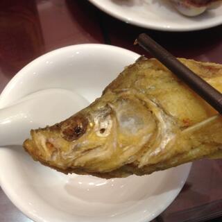 I grasp a small fish in my chopsticks.