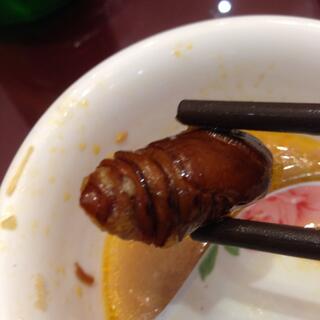 The dark body of a fried caterpiller.