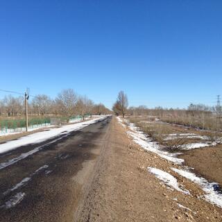 A country road with patches of snow.