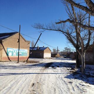 The loud hailer sound seemed to come from these brick buildings.