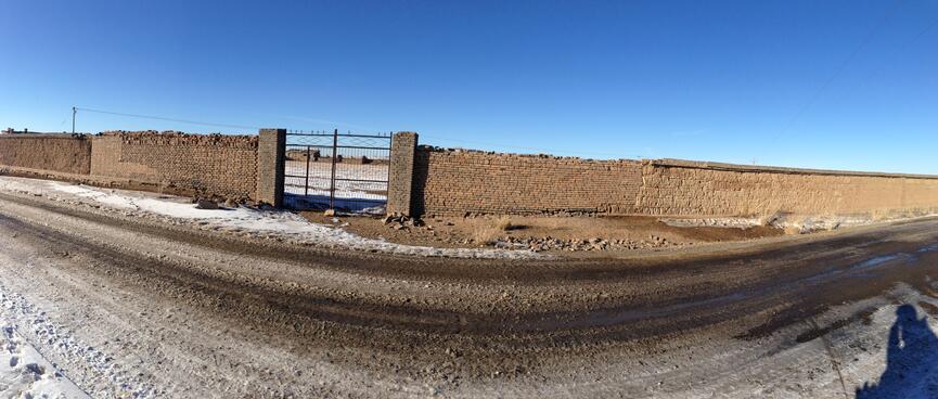 A long brick wall displays a variety of building techniques.