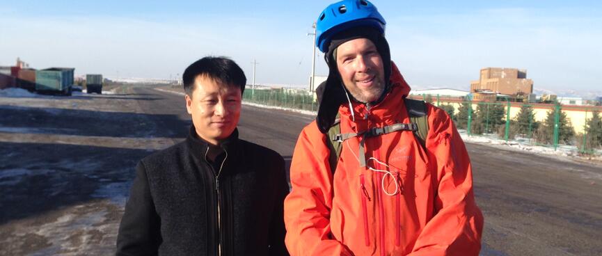 A Chinese man dressed in black and me in my cycling gear.