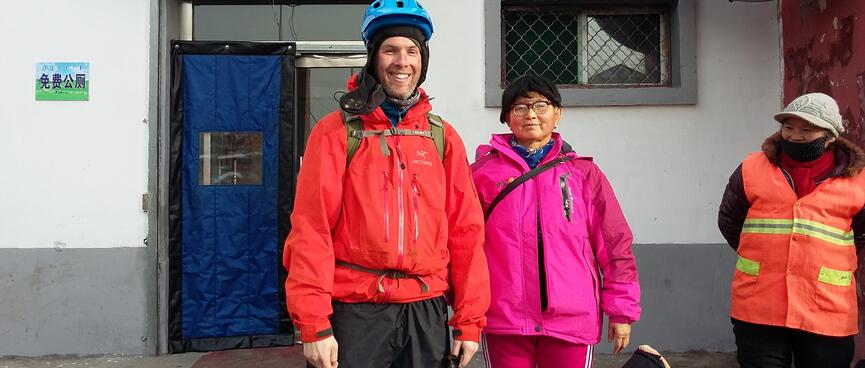 A lady in a pink Jack Wolfskin jumpsuit, and me in my cycling gear.