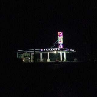 Animated LEDs outline the shape of a petrol station.