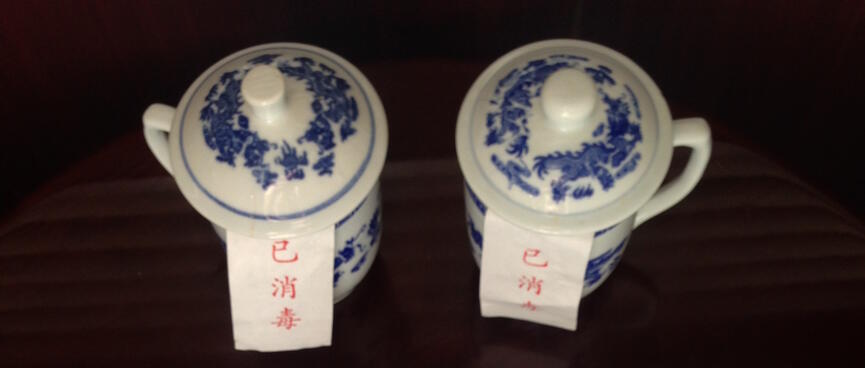 Porcelain tea strainers and packets of tea.