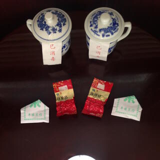 Porcelain tea strainers and packets of tea.
