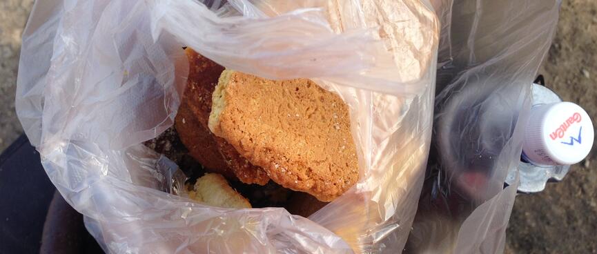 A plastic shopping bag containing different kinds of Chinese bread.