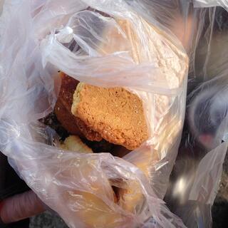 A plastic shopping bag containing different kinds of Chinese bread.