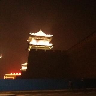 Huge medieval walls with glowing turrets.