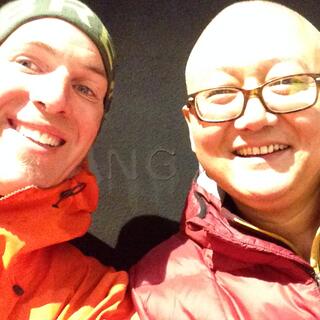 Zhihong in his red puffer jacket and I in my orange rain jacket.