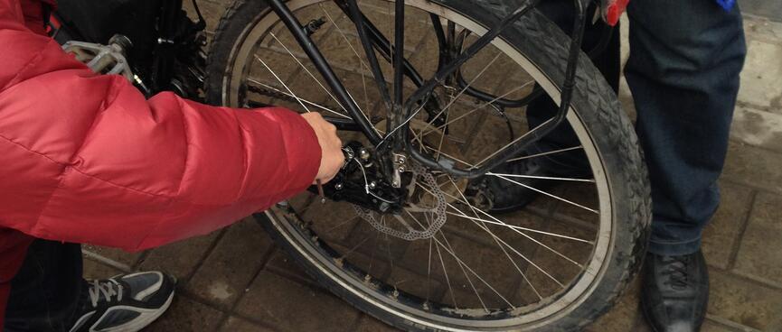 Zhihong tweaks the position of he rear disc brake.