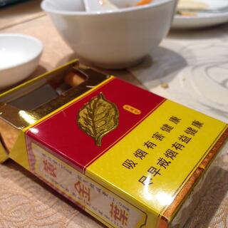 An almost empty packet of Chinese cigarettes features a tasteful leaf illustration and holographic highlights.