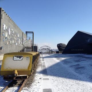 Empty golden carriages on a railway line.