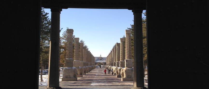 A long line of pillars flank a wide pathway.