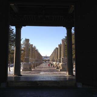 A long line of pillars flank a wide pathway.