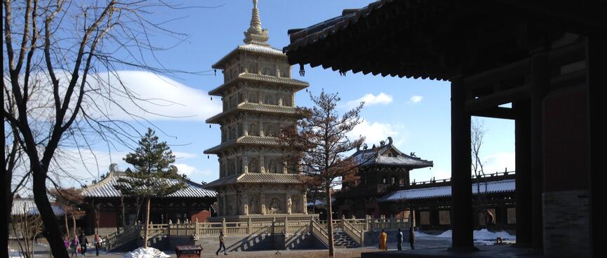A tower with five levels and a rooftop spike.