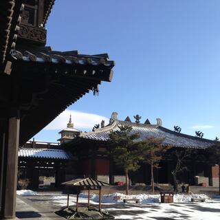 Close-up of roofs and eves with small metal decorations.