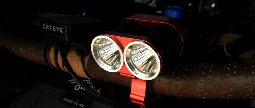 Red bar-mounted twin bulb MTB headlight.
