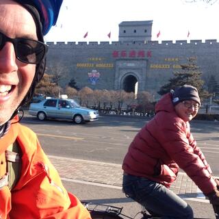 Zhihong and I ride two abreast on a cycleway.