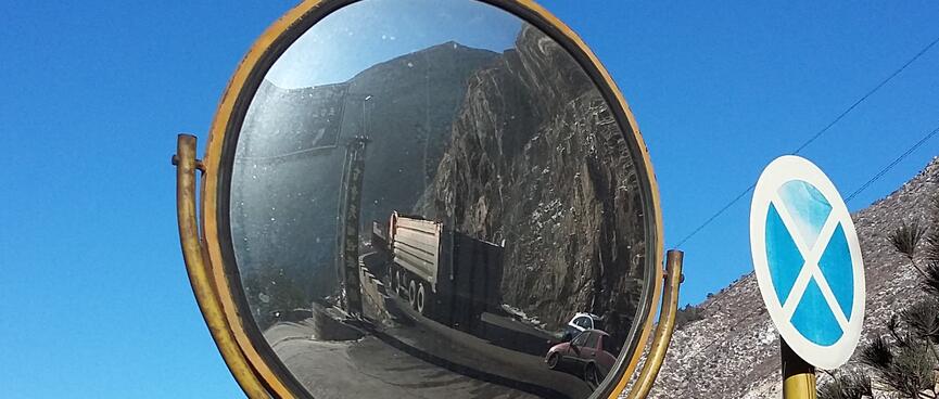 A convex mirror allows cars to see other traffic coming from around the corner.