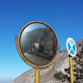 A convex mirror allows cars to see other traffic coming from around the corner.