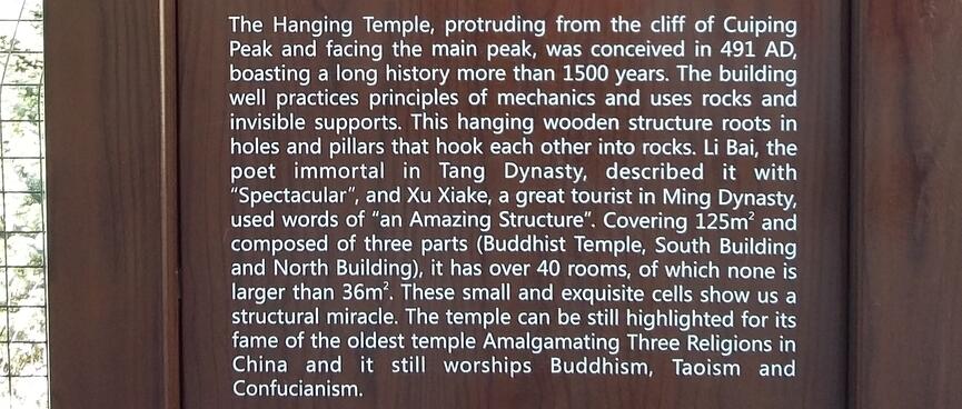 A wooden sign explaining the significance of the Hanging Temple.