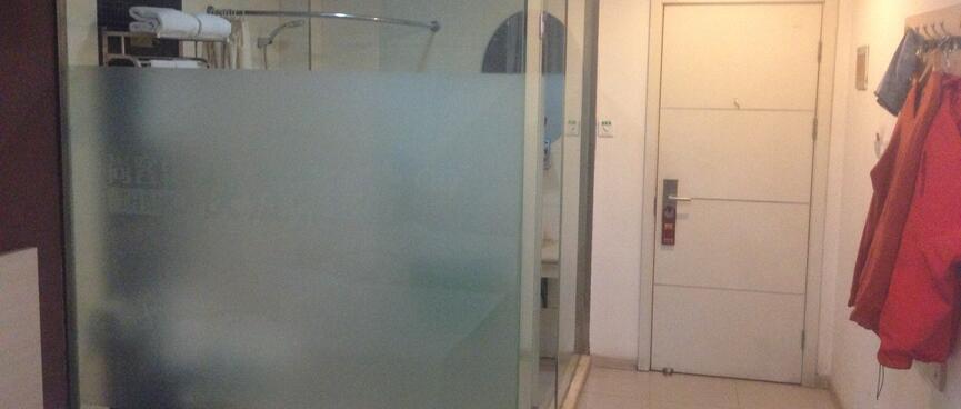 The bathroom has frosted glass walls.