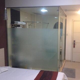 The bathroom has frosted glass walls.