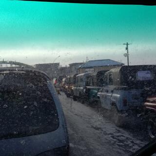 A long line of matching jeeps in different colours.
