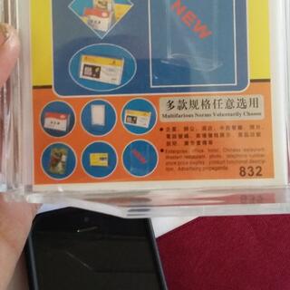 Plastic sign holder with icons and the text ʼMultifarious Norms Voluntarily Chooseʼ.