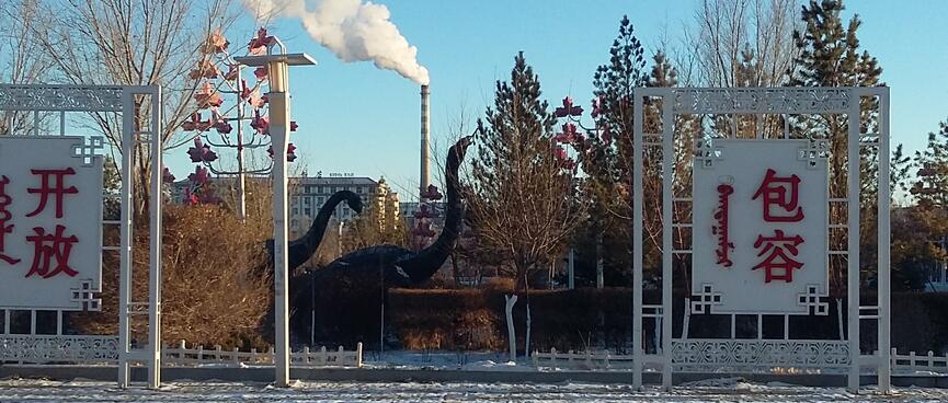 Dinosaur statues im a forrested area.
