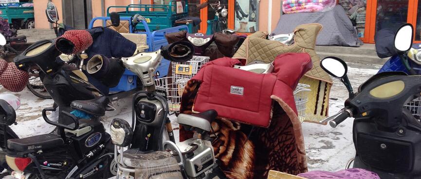 Gloves and quilts attached to the handlebars of motorised scooters.