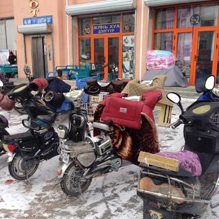 Gloves and quilts attached to the handlebars of motorised scooters.