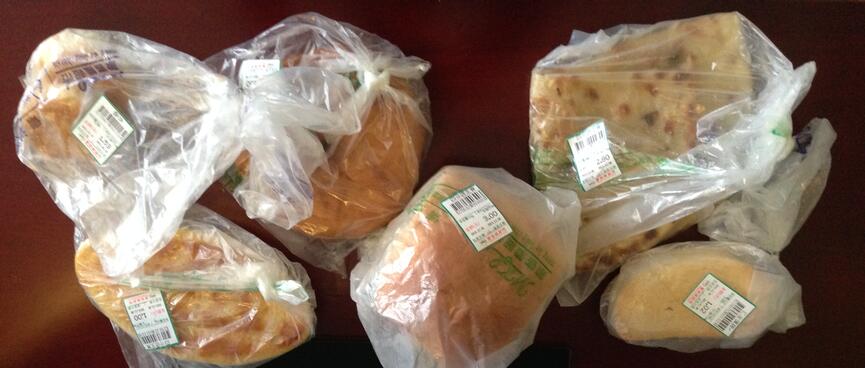 Six plastic bags containing baked goods.