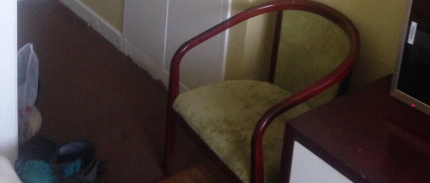 Yellow walls, white wardrobe doors and a sitting chair.