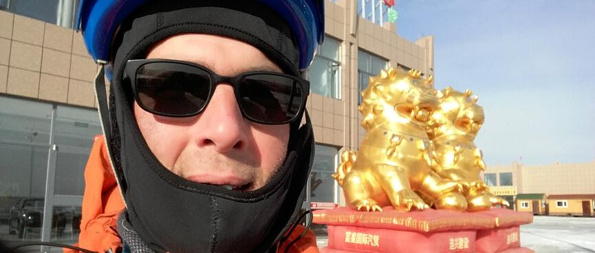 Selfie with two inflatable golden lion dogs.