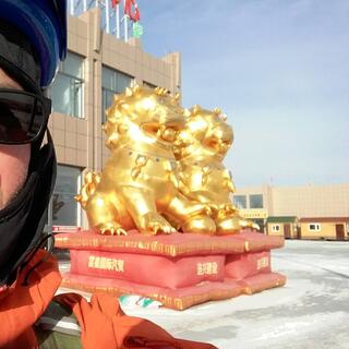 Selfie with two inflatable golden lion dogs.