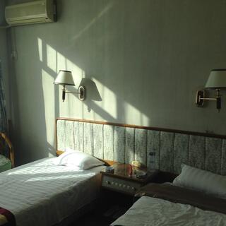 Window panes are projected against beds’ shared headboard.