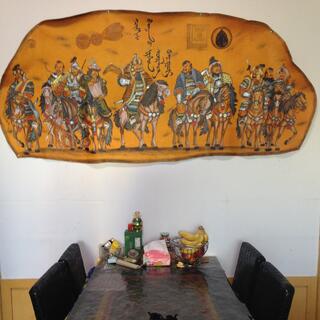 A painted illustration of many horse riders on a light brown background.