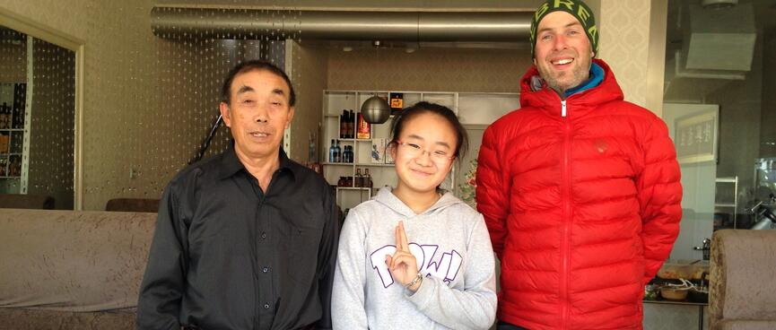 A man in black with a bunch of keys on his belt, a teenage girl in a hoody, and me.