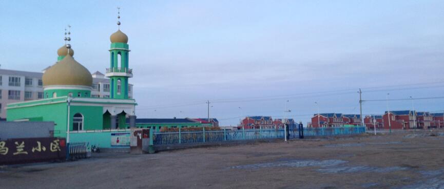A pastel green church with flared Russian style domes.