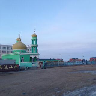A pastel green church with flared Russian style domes.