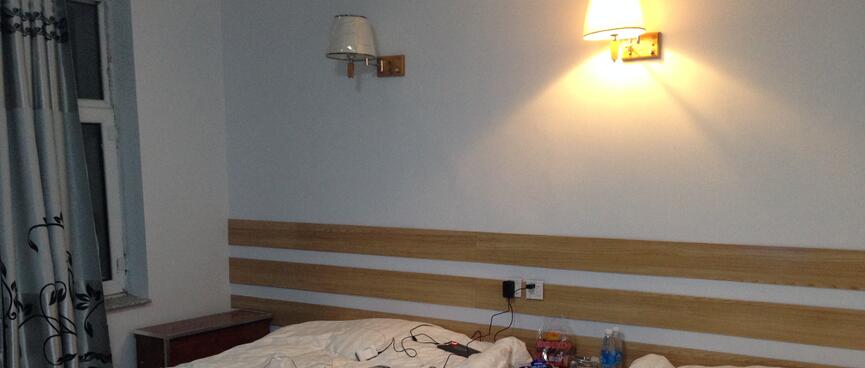 My electronics are laid out on two single beds.
