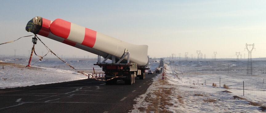 The truck continues on and the object is revealed as part of a wind turbine.
